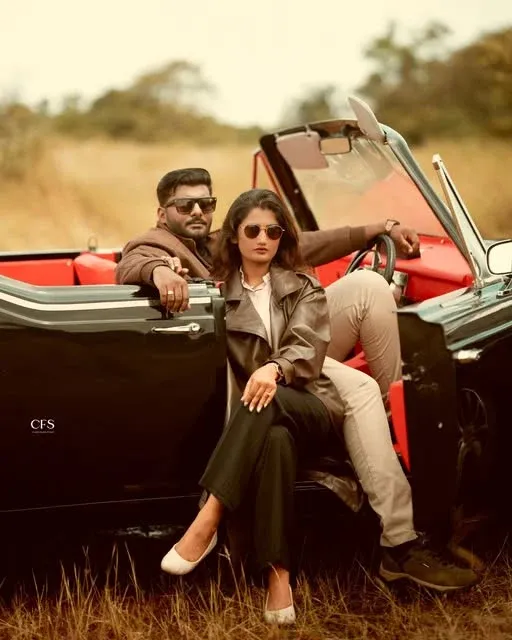 A couple in a red convertible at golden hour — Classic Frames Studios